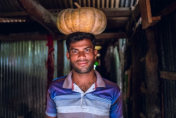 Noornobi carrying a pumpkin over his head